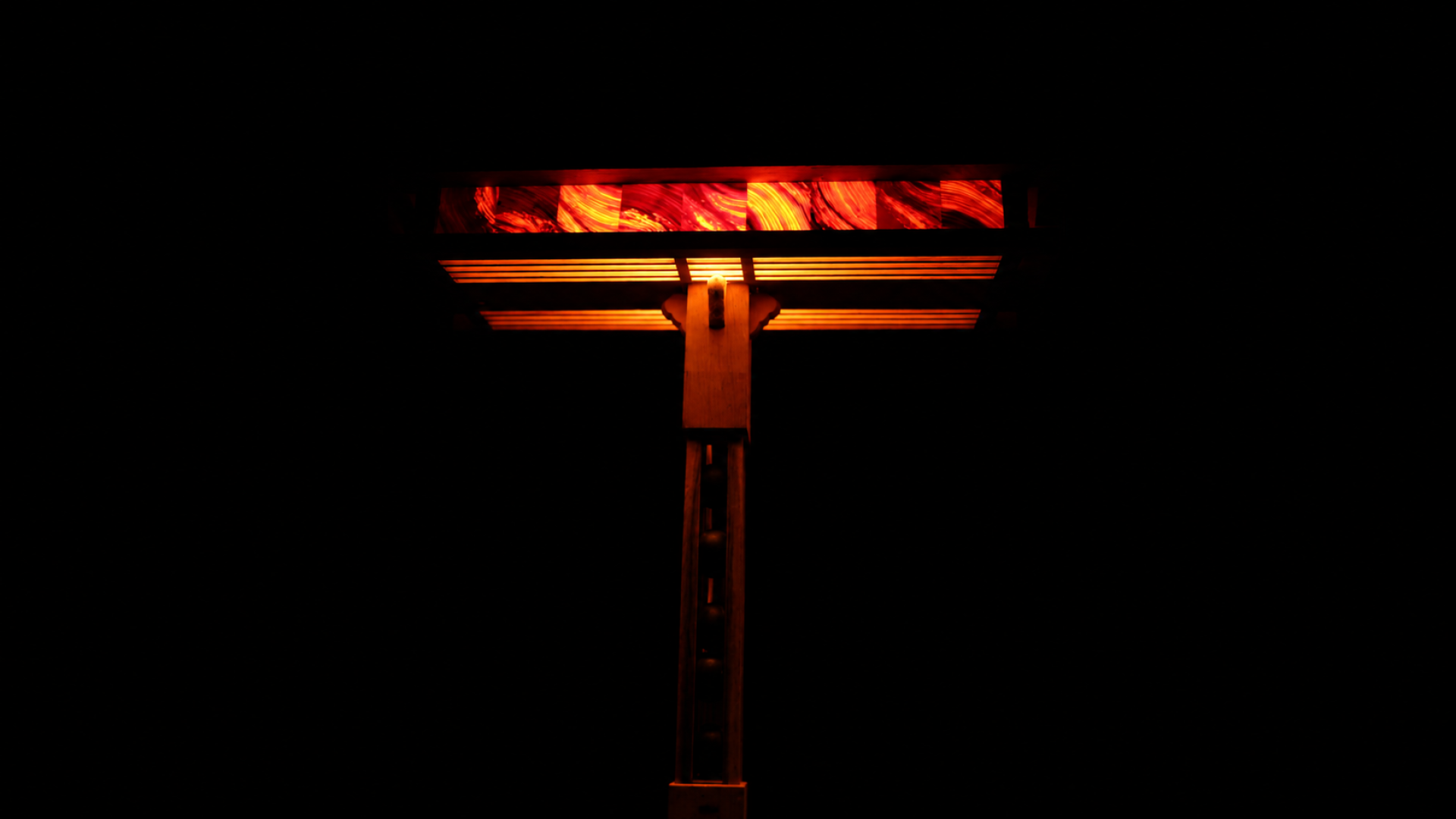 A rift in wood, reconnecting through light.