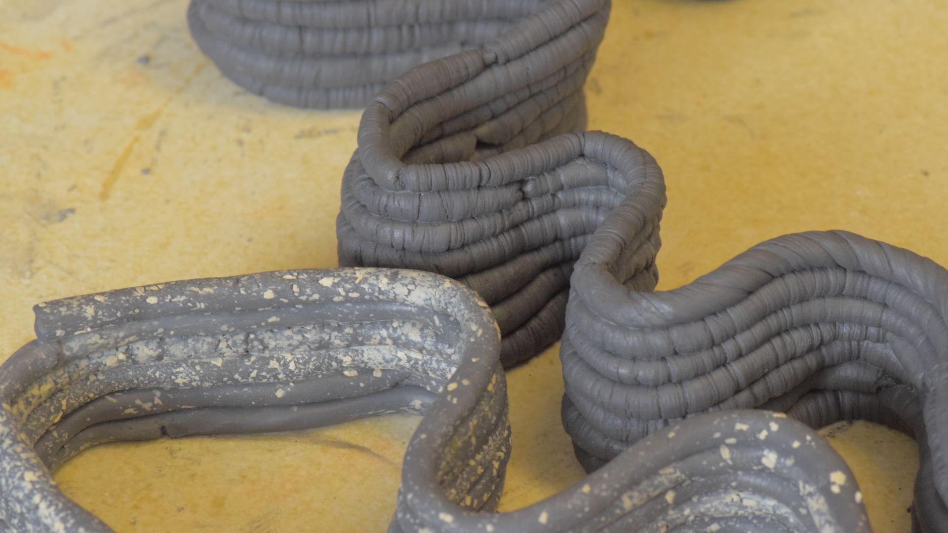 Hand coiling with textured layers.