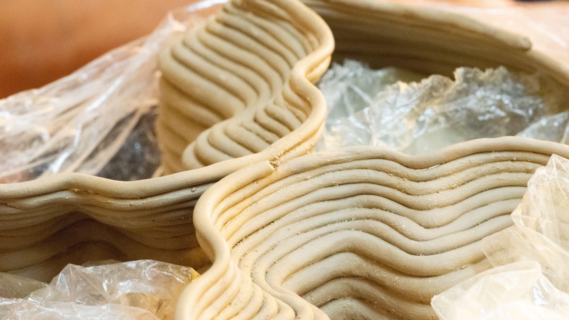 Hand coiling a work.