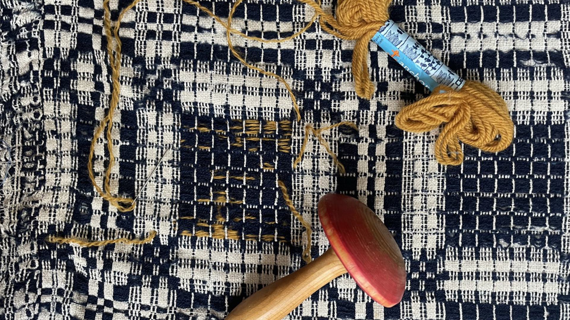 Darned antique coverlet.