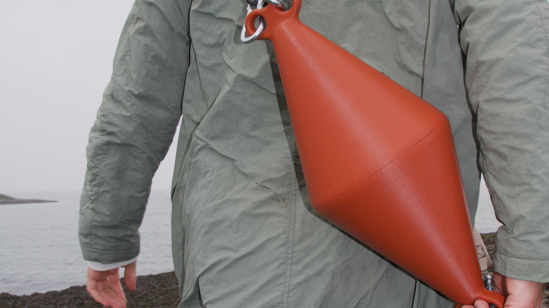 Red terracotta bag-buoy worn