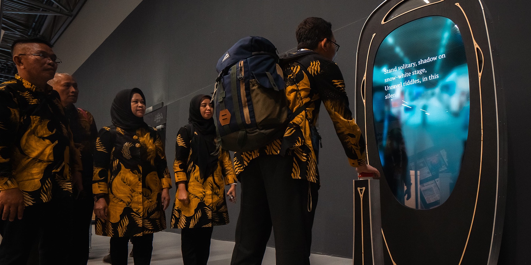 An Indonesian delegation trying out the Poem Booth