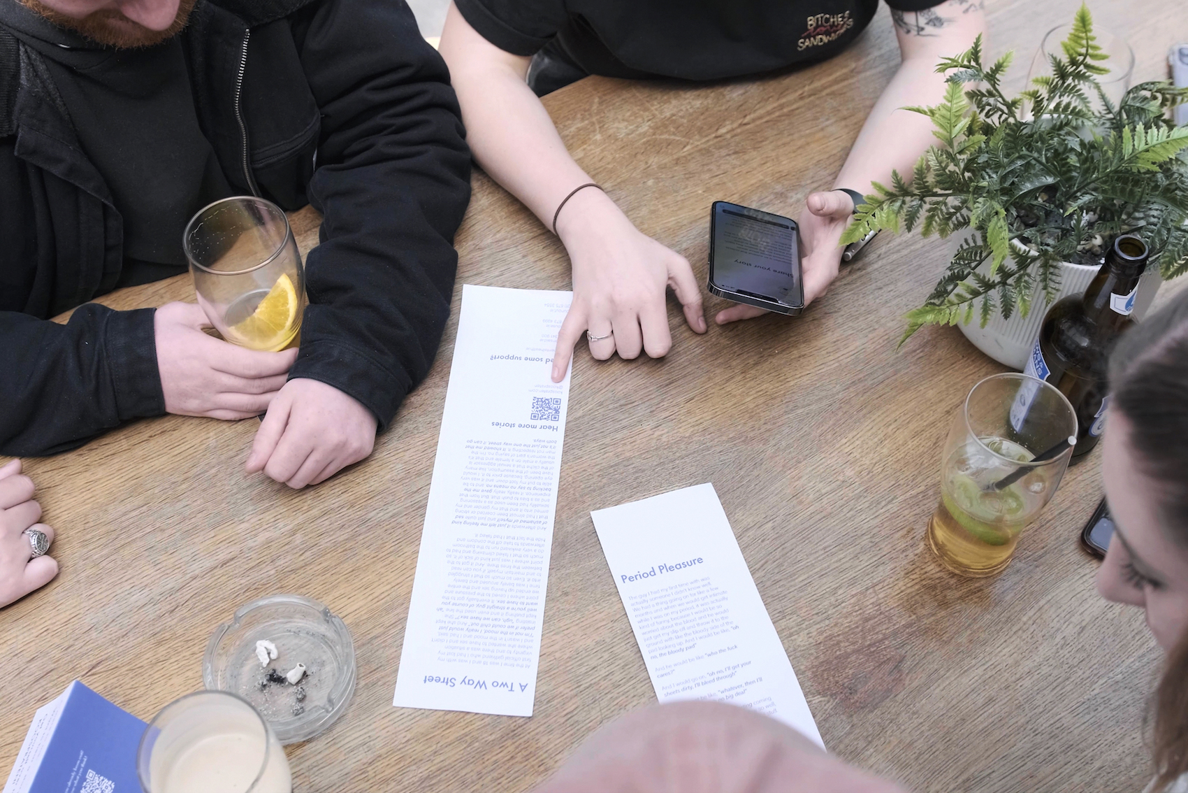 Friends discussing the takeaway printed stories