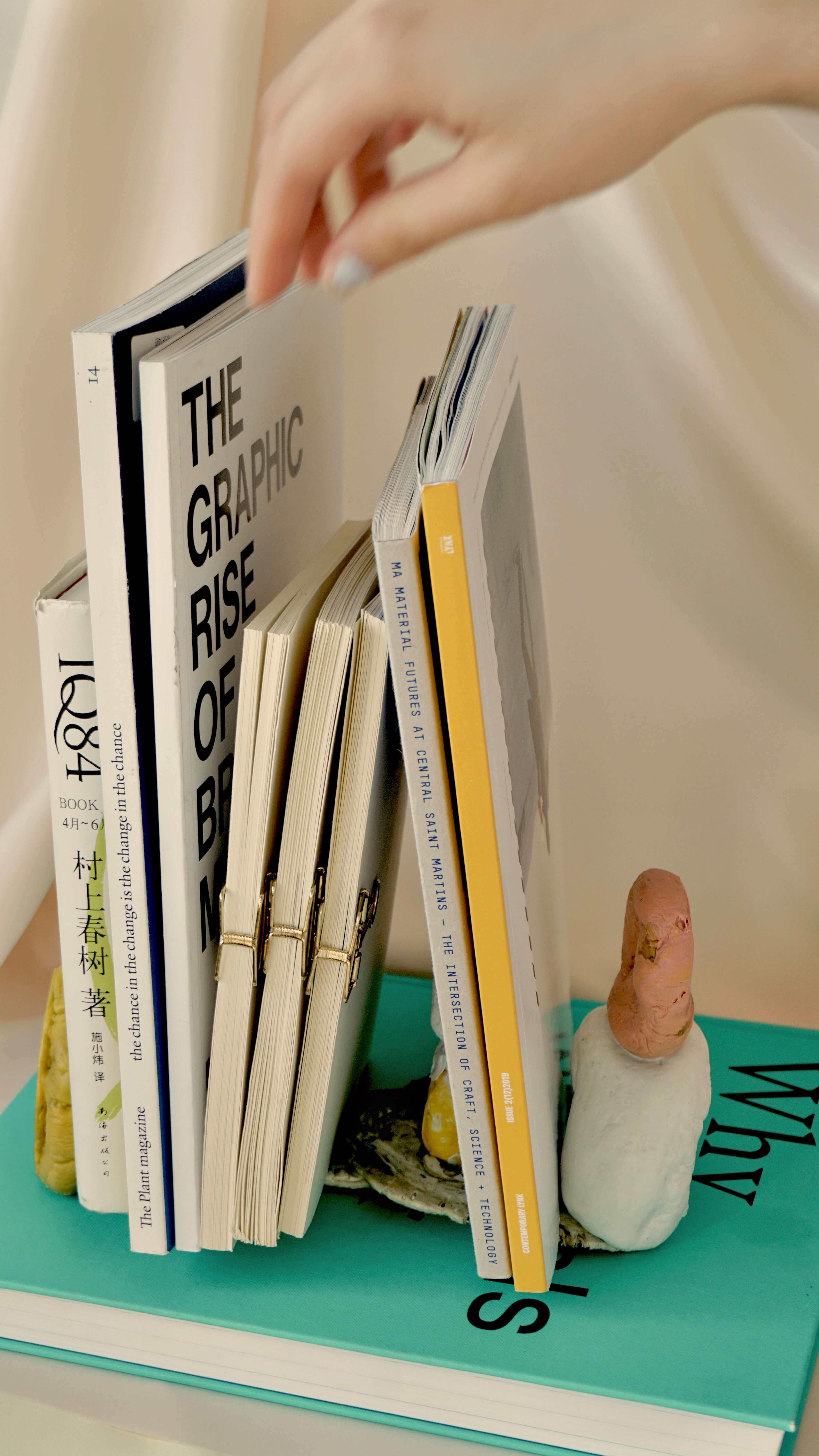 Placing book between book holders on bedside table