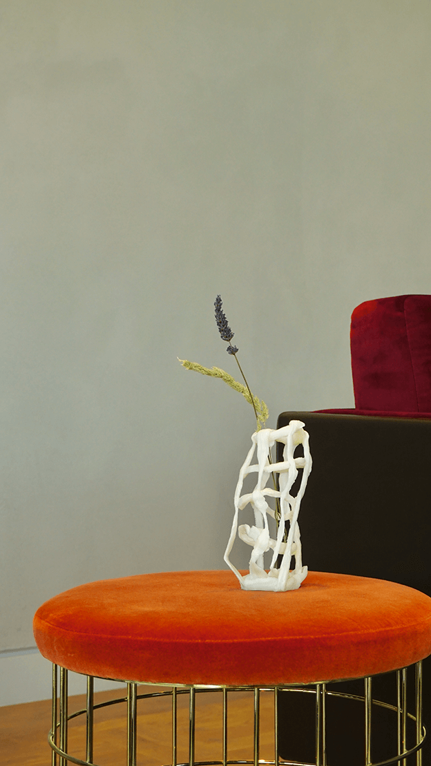 A vase made from waste plastic holding a flower