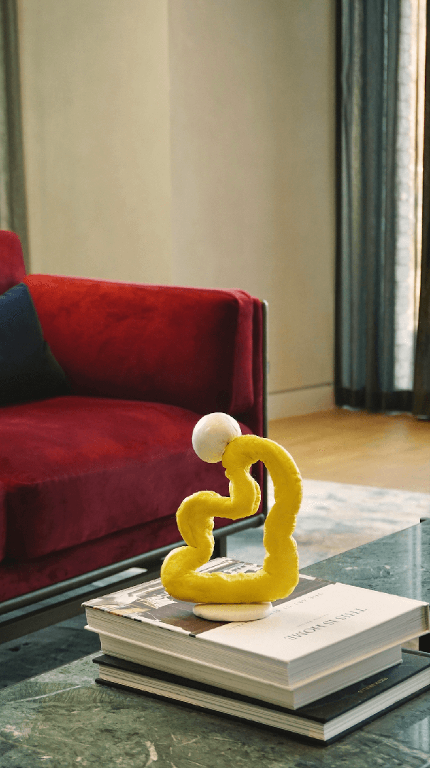 A sculpture made from waste plastic on a book.