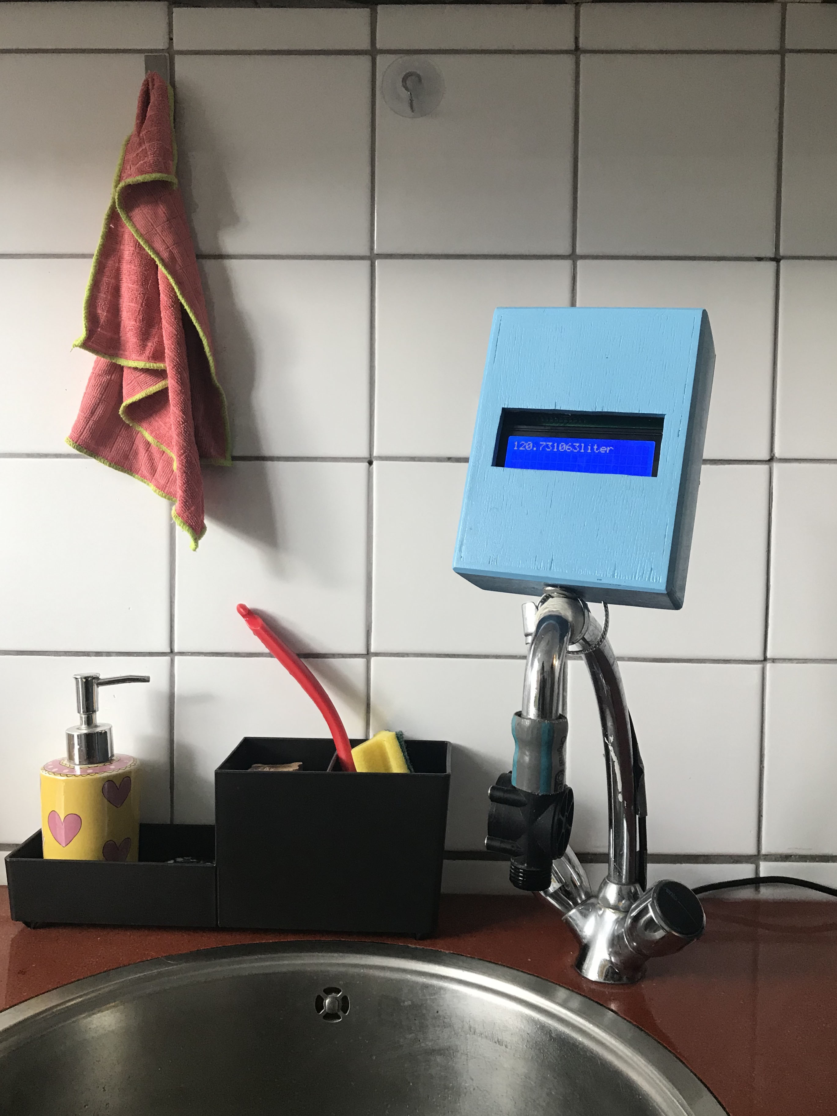 Flip, the Water Counter installed on a faucet.