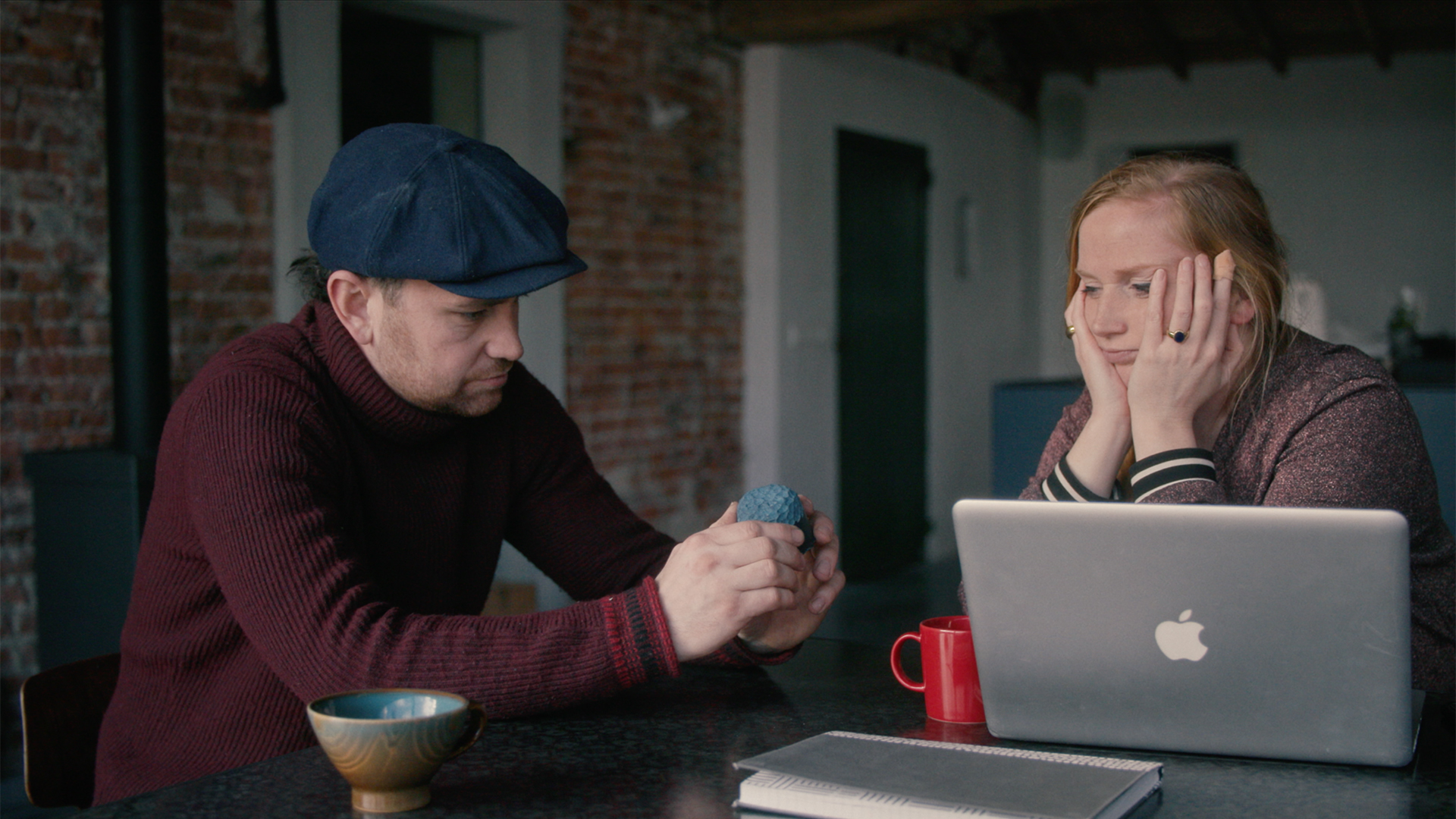 Discussing a design (still from the movie)