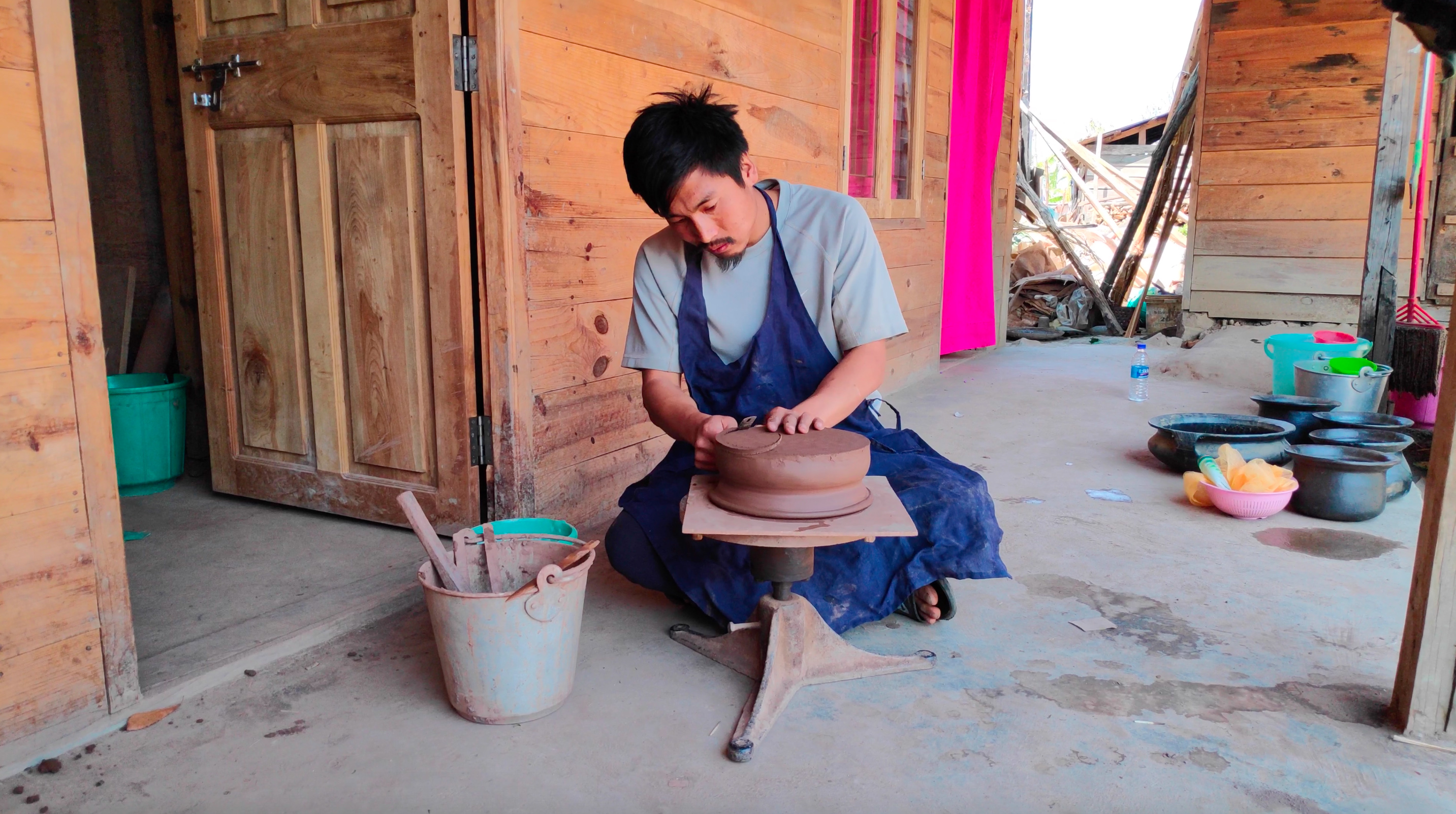 Finishing the pot after it's been coiled by hand