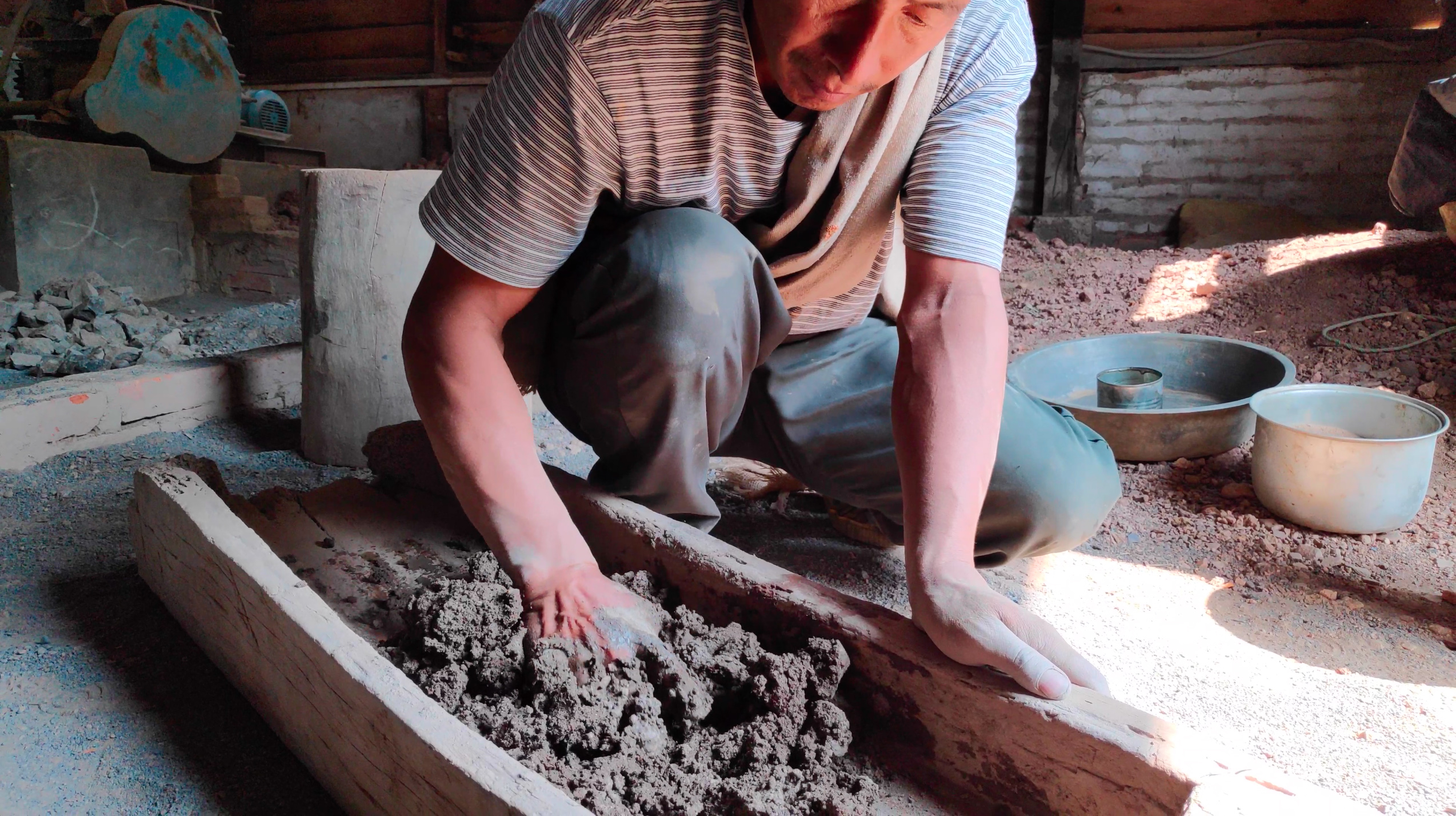 Mixing crushed Serpentine stone with river clay