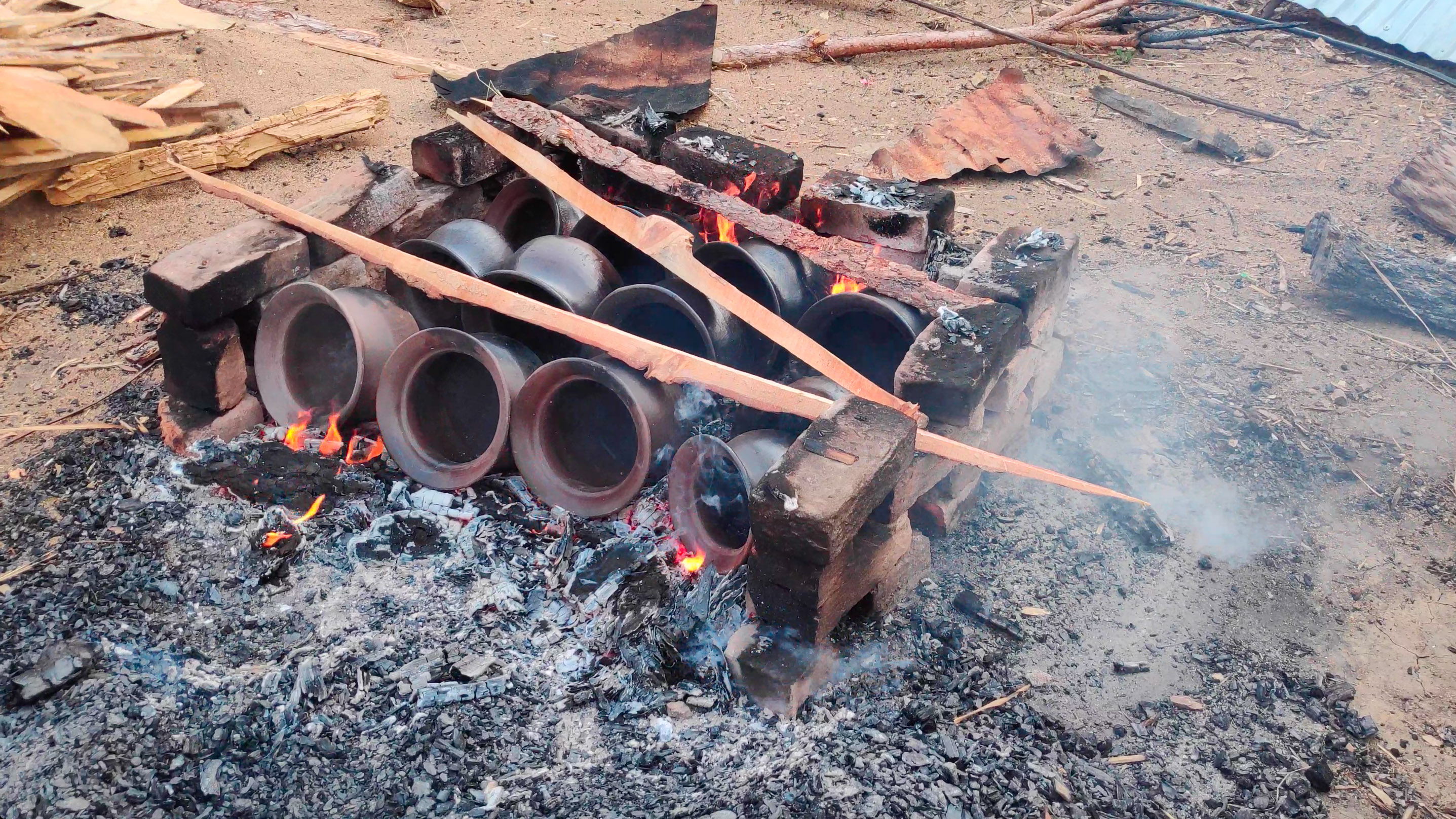 Firing the pots in an open makeshift bonfire