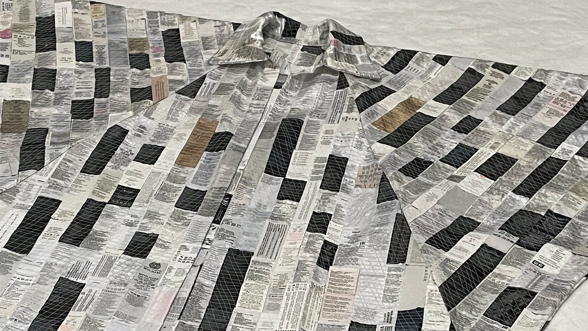 Coat made of labels from discarded clothes