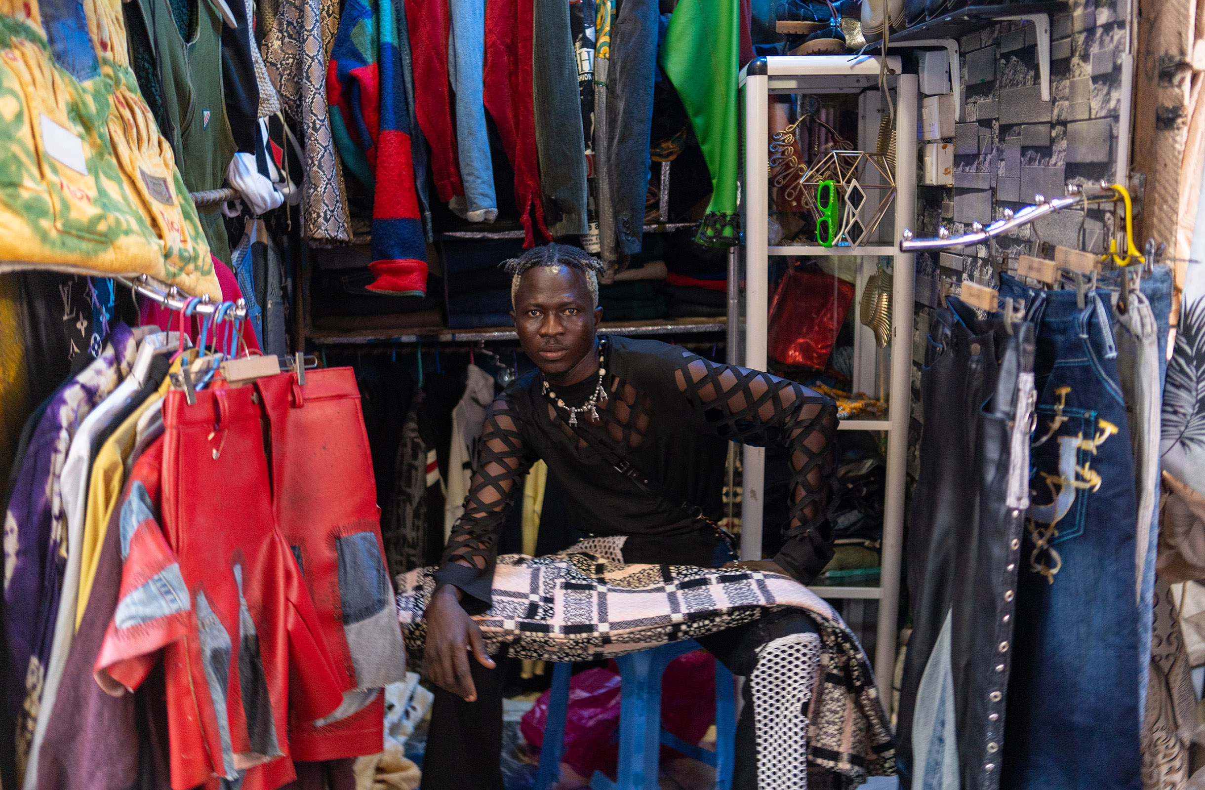 Designer at his upcycled fashion shop.