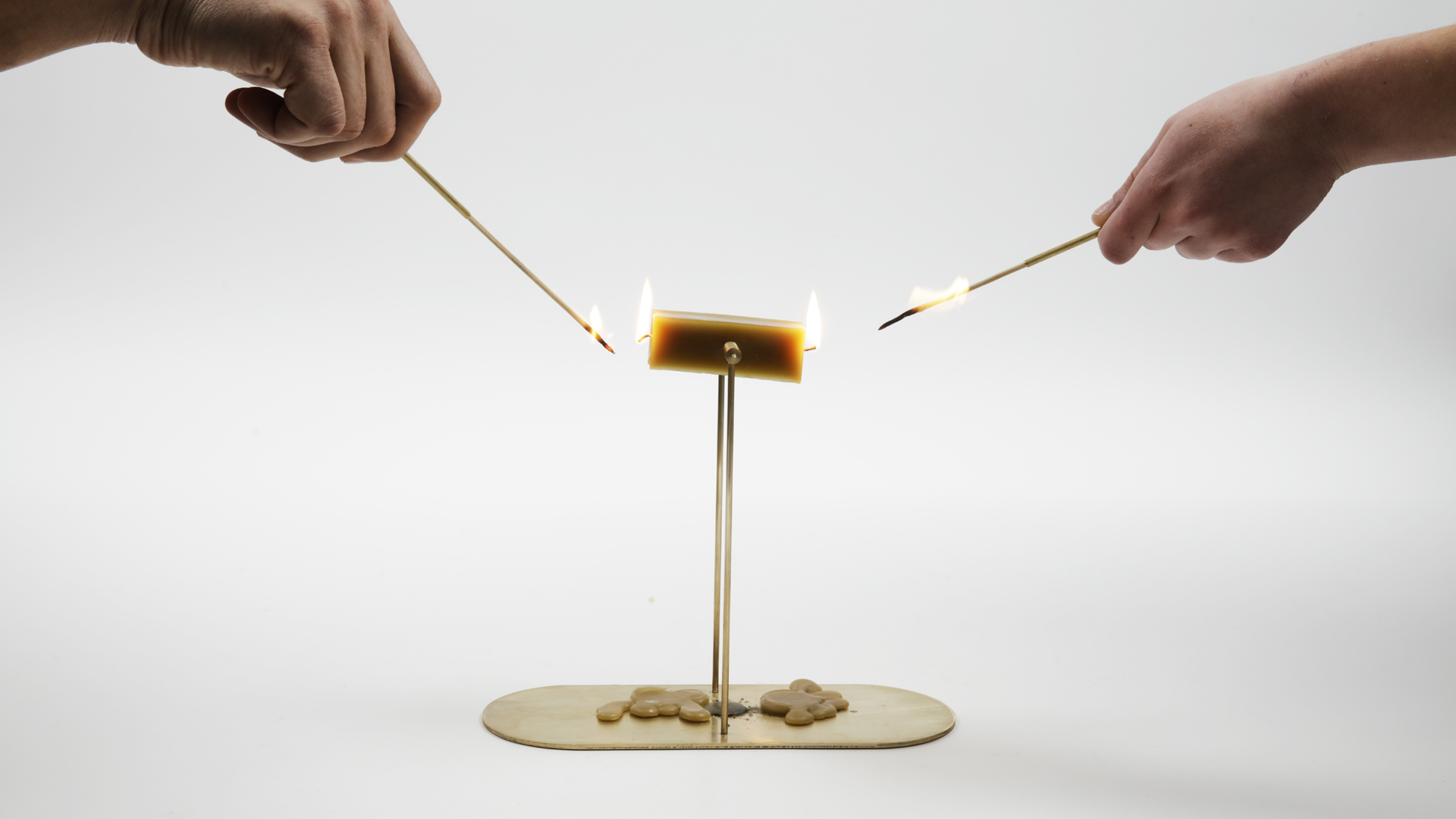 Light the wicks together, the candles will spin.