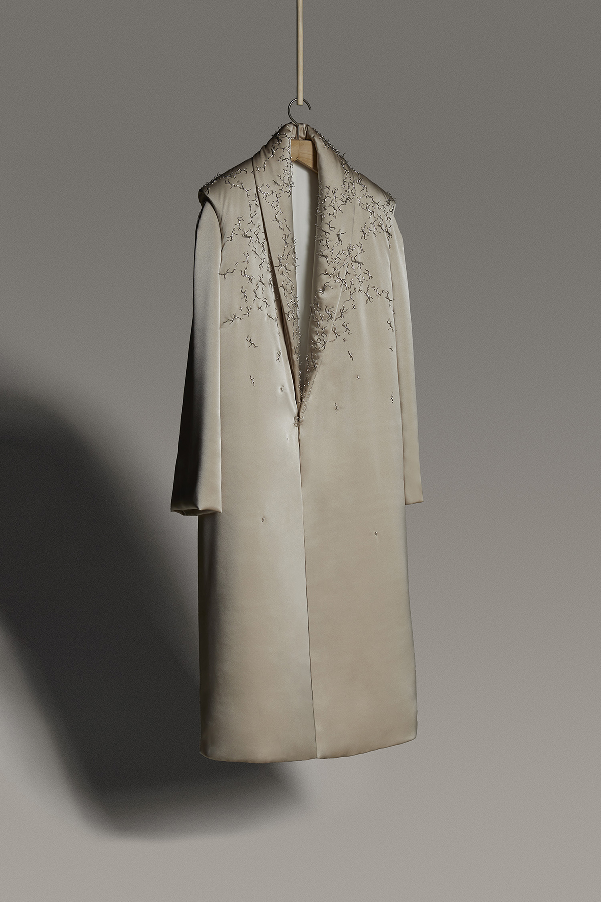 Heirloom coat with metal details on padded textile