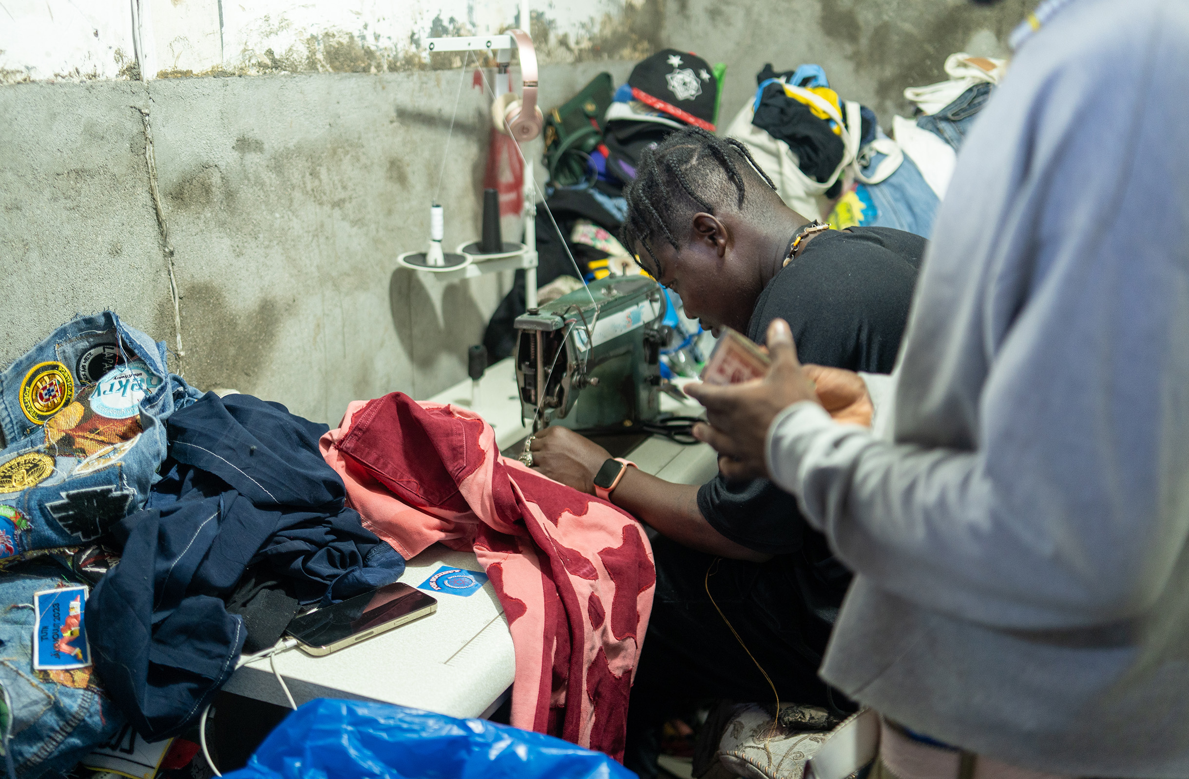 Designer at his shop, creating an upcycled piece.