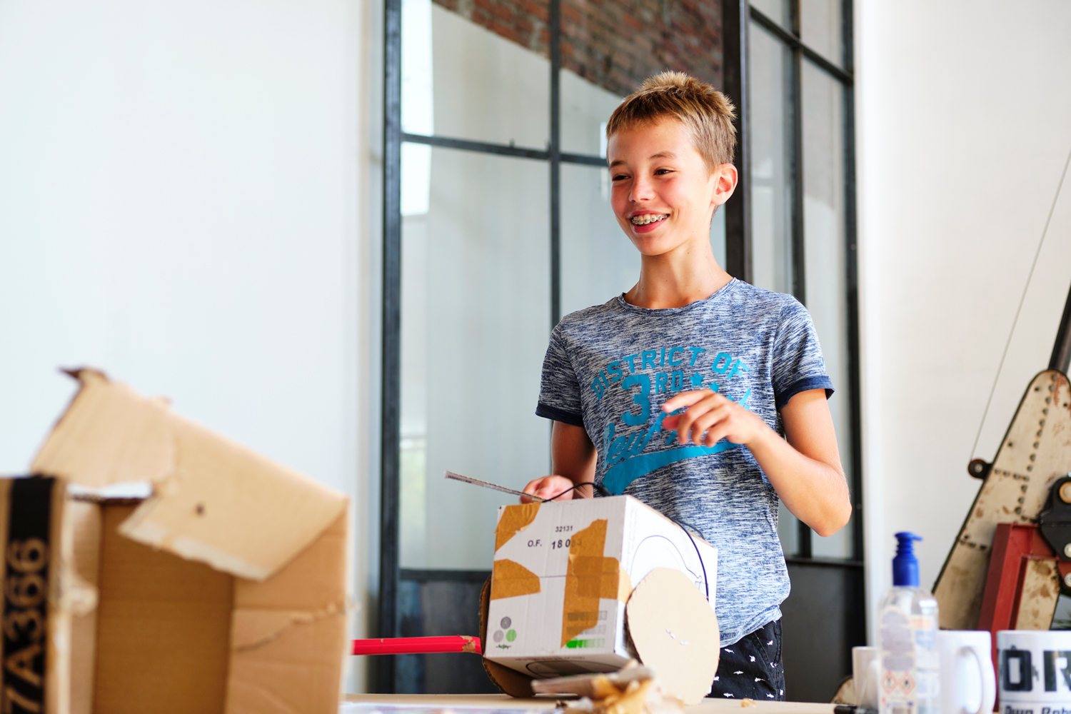 Boy presents his robot