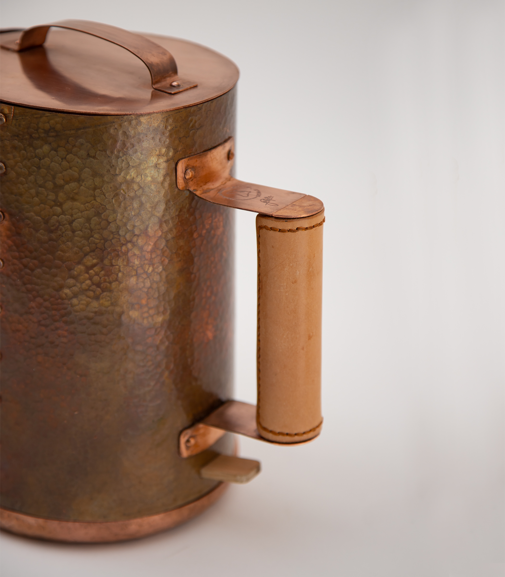 Leather wrapped handle attached with copper rivets